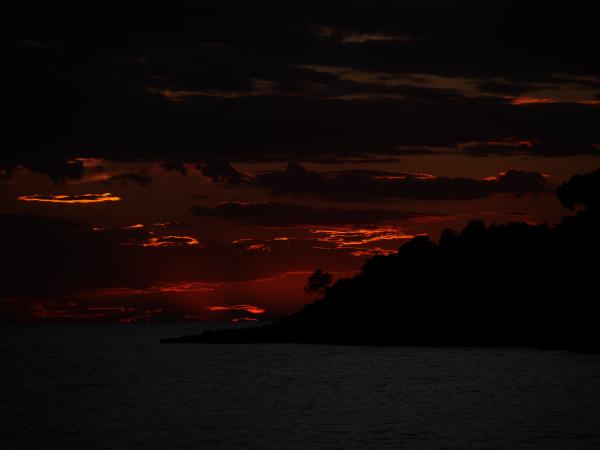A dramatic sunset with dark clouds creating a hellish ambiance in the sky.