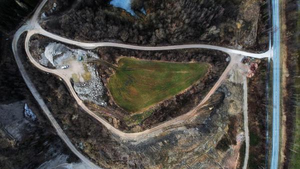 Aerial view of a piece of land with intricate patterns made by the arrangement of trees and pathways.