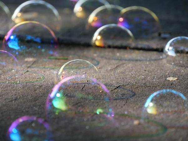 Soap bubbles on a piece of wood.