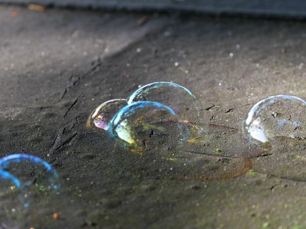Soap bubbles on a piece of wood. Focus on a group of bubbles.