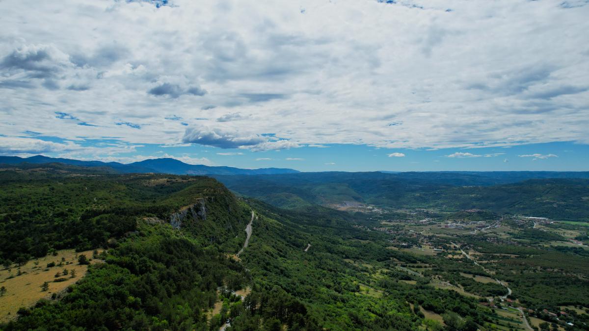 Image of little mountains / hills and a railroad track snaking along them.