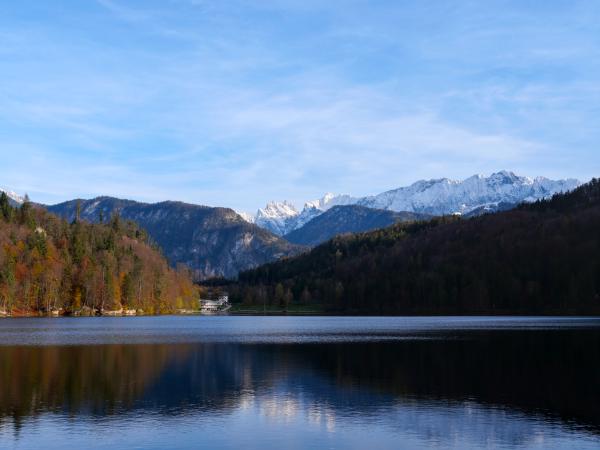 A lake with snow-covered mountains in the background.