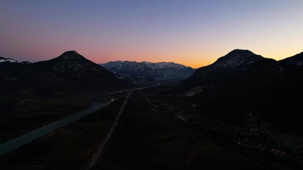 Evening view of mountains with their silhouettes stark against the twilight sky.