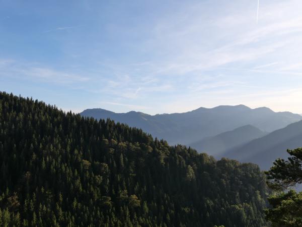 An image of mountains and light which shines beautifully between them.