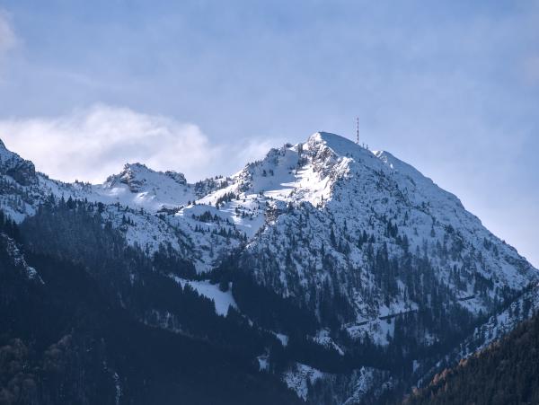 The Wendelstein mountain in Bavaria, Germany covered in snow. There is an antenna on top of the mountain.