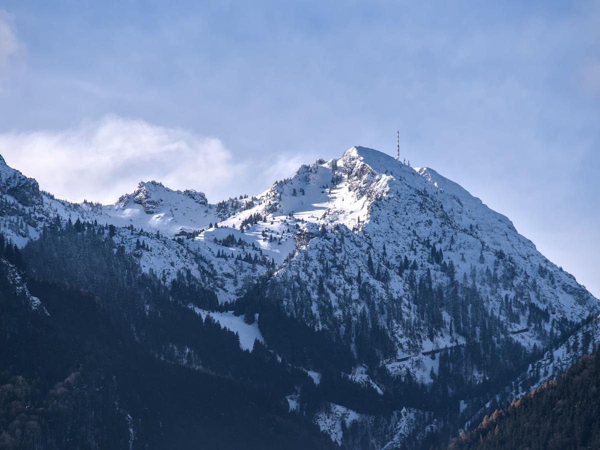 The Wendelstein mountain in Bavaria, Germany covered in snow. There is an antenna on top of the mountain.